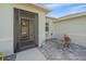 Front entry with a screened-in door and a sitting area with stone-like tile at 8755 Dolomite Ave, North Port, FL 34287