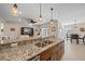Granite kitchen island with double sinks and breakfast bar seating at 8755 Dolomite Ave, North Port, FL 34287