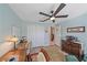 Home office with wooden desk, chair, and ceiling fan at 8755 Dolomite Ave, North Port, FL 34287