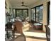 Relaxing screened porch with wicker furniture and ceiling fan at 8755 Dolomite Ave, North Port, FL 34287