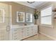 Elegant bathroom with double sinks, large mirrors, and a frameless shower at 8912 Heritage Sound Dr, Bradenton, FL 34212