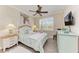 Bedroom with a ceiling fan, dresser, and large window with plantation shutters at 8912 Heritage Sound Dr, Bradenton, FL 34212