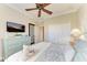Bedroom with a light teal dresser, ceiling fan, and comfortable bedding at 8912 Heritage Sound Dr, Bradenton, FL 34212