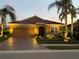 Attractive single-story home with a well-manicured lawn and palm trees at 8912 Heritage Sound Dr, Bradenton, FL 34212
