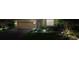 Night view of a house with landscaped yard, driveway, and exterior lighting at 8912 Heritage Sound Dr, Bradenton, FL 34212