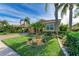 House with a well-manicured lawn, palm trees, and a brick paved driveway at 8912 Heritage Sound Dr, Bradenton, FL 34212