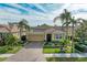 Single-story home with tile roof, landscaped yard, and paved driveway at 8912 Heritage Sound Dr, Bradenton, FL 34212
