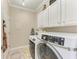 Laundry room with washer, dryer, and cabinets at 8912 Heritage Sound Dr, Bradenton, FL 34212