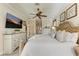 Spacious main bedroom with large TV, dresser and ensuite bathroom access at 8912 Heritage Sound Dr, Bradenton, FL 34212