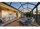 Spacious screened lanai with patio furniture, string lights, and a dining area at 8912 Heritage Sound Dr, Bradenton, FL 34212