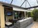 Relaxing screened lanai with wicker furniture, offering comfort and outdoor living space at 8912 Heritage Sound Dr, Bradenton, FL 34212