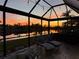 Enjoy breathtaking sunsets from this screened lanai with comfortable lounge chairs at 8912 Heritage Sound Dr, Bradenton, FL 34212
