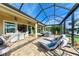 Large screened patio with lounge chairs and dining area at 8912 Heritage Sound Dr, Bradenton, FL 34212