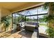 Covered patio with seating and fire pit overlooking the water at 8912 Heritage Sound Dr, Bradenton, FL 34212