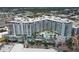 Aerial view of a modern apartment building with pool and city views at 111 S Pineapple Ave # 1102, Sarasota, FL 34236