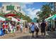 Vibrant outdoor farmers market with various vendors and shoppers at 111 S Pineapple Ave # 1102, Sarasota, FL 34236