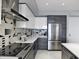 Modern kitchen with stainless steel appliances and geometric backsplash at 111 S Pineapple Ave # 1102, Sarasota, FL 34236