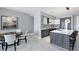 Modern kitchen with island, stainless steel appliances, and marble flooring at 111 S Pineapple Ave # 1102, Sarasota, FL 34236