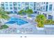 Relaxing pool area with multiple lounge chairs and palms at 111 S Pineapple Ave # 1102, Sarasota, FL 34236