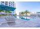 Resort-style pool with ample lounge chairs and umbrellas at 111 S Pineapple Ave # 1102, Sarasota, FL 34236