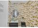 Stylish powder room with modern vanity and gold leaf wallpaper at 111 S Pineapple Ave # 1102, Sarasota, FL 34236