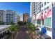 Modern building with palm trees and shops on a city street at 111 S Pineapple Ave # 1102, Sarasota, FL 34236