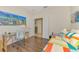 Bright bedroom with a daybed, workspace, and hardwood floors at 1344 Backspin Dr, Englewood, FL 34223