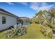 Landscaped backyard with lush tropical plants and canal view at 15808 42Nd E Gln, Parrish, FL 34219
