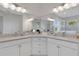 Double vanity bathroom with corner sinks and white cabinets at 15808 42Nd E Gln, Parrish, FL 34219