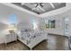 Main bedroom with a white bed frame and access to the lanai at 15808 42Nd E Gln, Parrish, FL 34219