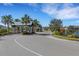 Gated community entrance with palm trees and landscaping at 15808 42Nd E Gln, Parrish, FL 34219