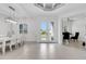 Bright dining room with white table and chairs, and access to an office at 15808 42Nd E Gln, Parrish, FL 34219
