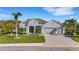 Single-story home with gray siding, tile roof, and a 3-car garage at 15808 42Nd E Gln, Parrish, FL 34219