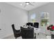 Home office with two black chairs and plenty of natural light at 15808 42Nd E Gln, Parrish, FL 34219