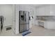 Modern kitchen with stainless steel refrigerator and white cabinetry at 15808 42Nd E Gln, Parrish, FL 34219