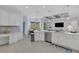 Bright kitchen with white cabinets, herringbone backsplash, and an island at 15808 42Nd E Gln, Parrish, FL 34219