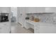 White kitchen with built-in desk and herringbone backsplash at 15808 42Nd E Gln, Parrish, FL 34219