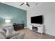 Recreation room features a stylish accent wall, built-in shelving, and a fireplace at 15808 42Nd E Gln, Parrish, FL 34219