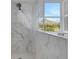 Shower with marble tile and a window at 15808 42Nd E Gln, Parrish, FL 34219