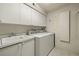 Laundry room with washer, dryer, and cabinets at 1600 W Marion Ave # 213, Punta Gorda, FL 33950
