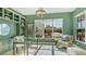 Home office with built-in shelving, glass desk, and a comfortable armchair at 16511 Cornwall Ln, Bradenton, FL 34202