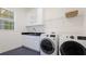 Laundry room with washer, dryer, and ample storage at 16511 Cornwall Ln, Bradenton, FL 34202