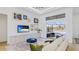 Bright living room features a large sectional sofa, a pool view, and an entertainment center at 16511 Cornwall Ln, Bradenton, FL 34202