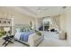 Spacious main bedroom with large windows, plush bedding, and a sitting area at 16511 Cornwall Ln, Bradenton, FL 34202