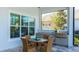 Covered patio with outdoor kitchen, dining table, and built-in grill at 16511 Cornwall Ln, Bradenton, FL 34202