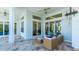 Outdoor patio with wicker furniture, adjacent to the pool and featuring sliding glass doors at 16511 Cornwall Ln, Bradenton, FL 34202