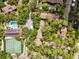 Overhead view of community pool, tennis courts, and lush landscaping at 1704 Pelican Cove Rd # T138, Sarasota, FL 34231