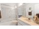 Bathroom with tub, shower, and beige vanity at 1704 Pelican Cove Rd # T138, Sarasota, FL 34231