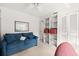Bedroom with blue couch, built-in shelving, and closet at 1704 Pelican Cove Rd # T138, Sarasota, FL 34231