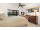 Spacious bedroom with large window, dresser, and ceiling fan at 1704 Pelican Cove Rd # T138, Sarasota, FL 34231